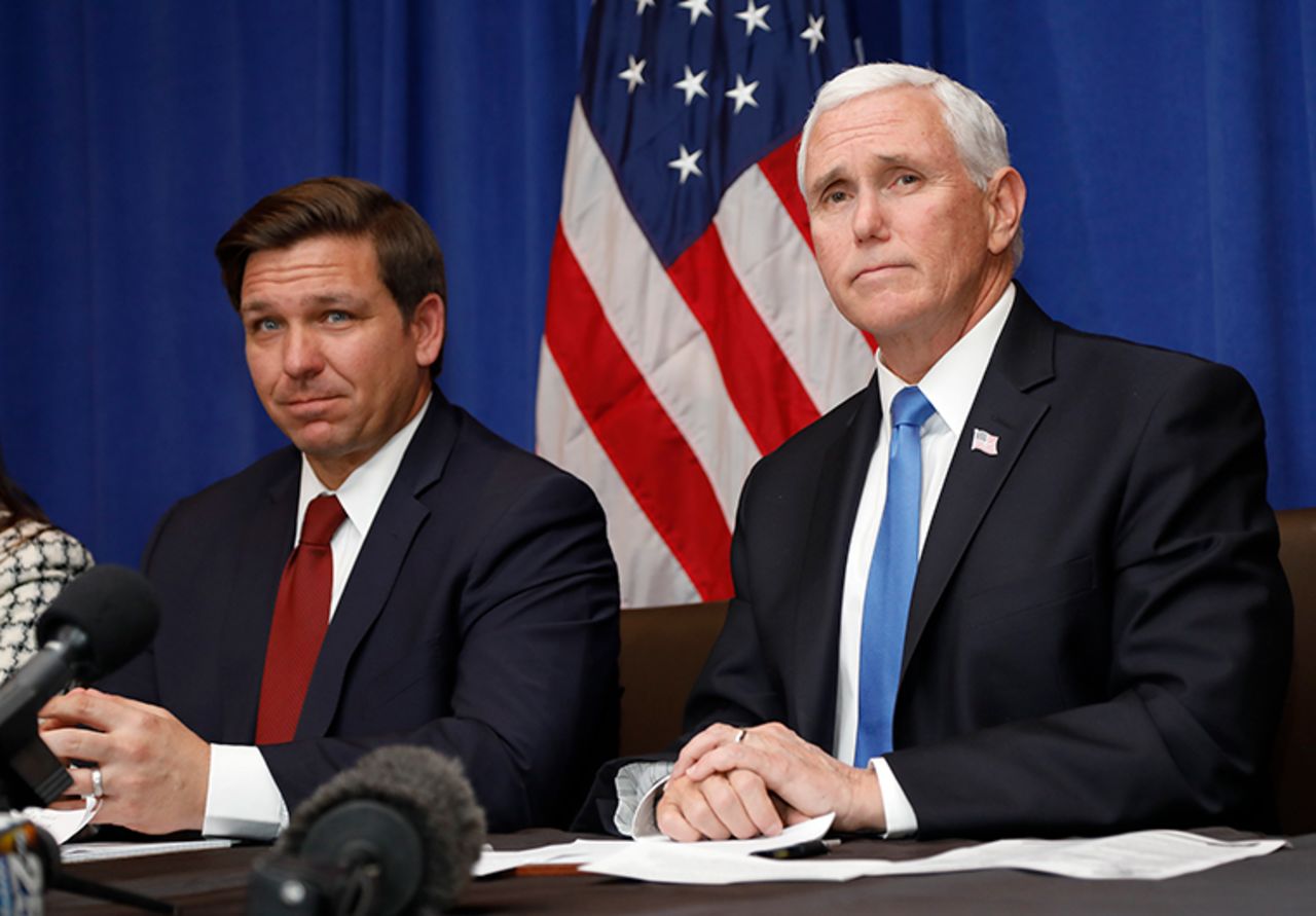 Florida Gov. Ron DeSantis and Vice President Mike Pence, right, take questions during a Florida Coronavirus Response Meeting, at the West Palm Beach International Airport, Friday, February 28, in West Palm Beach, Florida. 