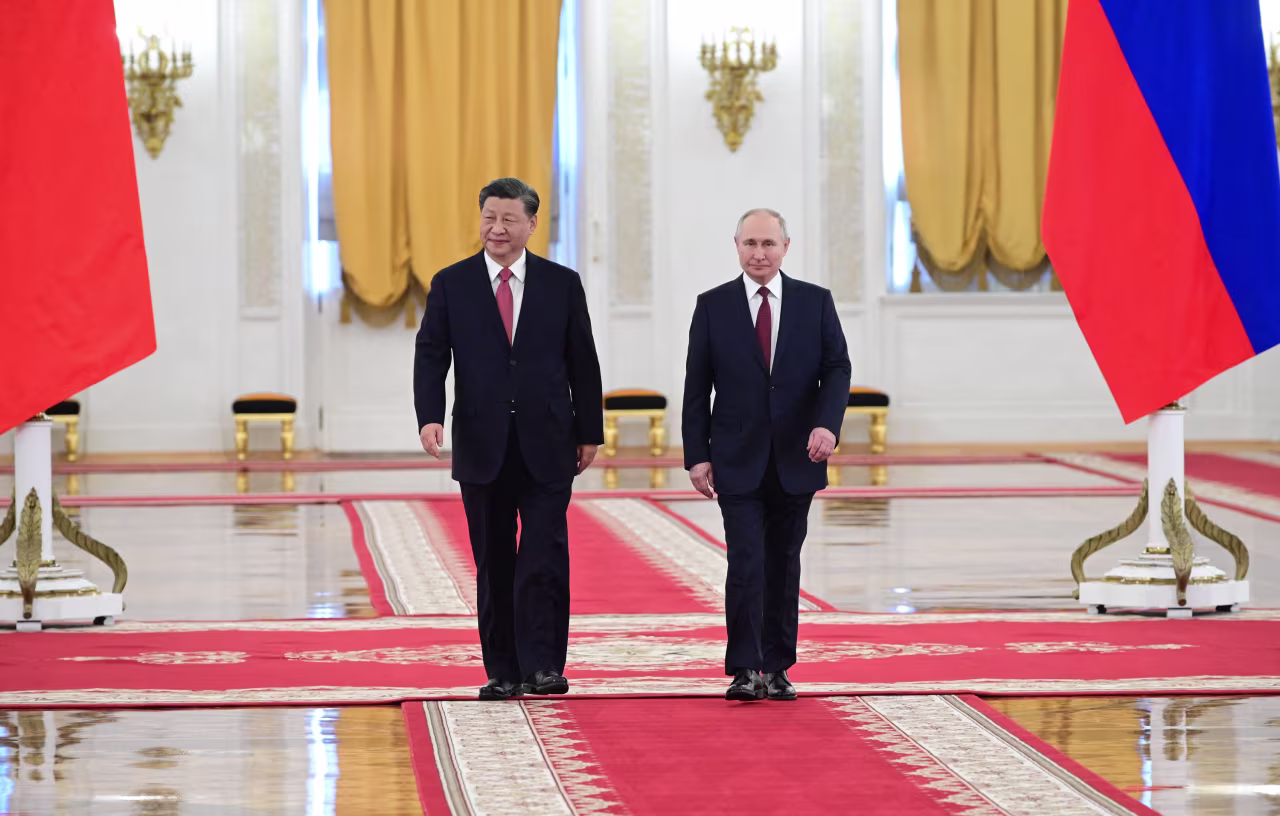 Russian President Vladimir Putin meets with Chinese President Xi Jinping at the Kremlin in Moscow on Tuesday.
