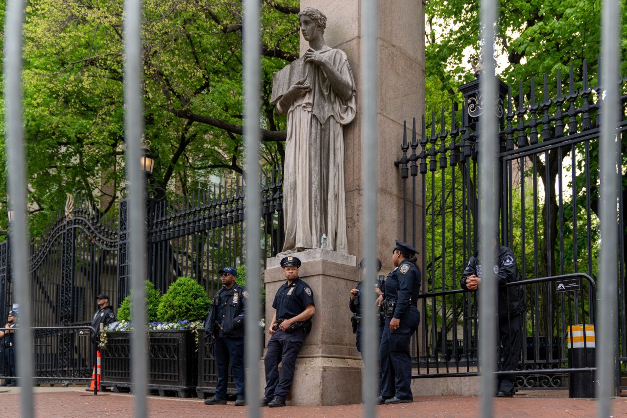 Private security and NYPD police officers stand guard at the gates of Columbia University on May 2. 