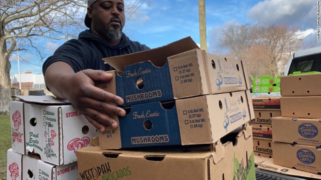 Chef Maxcel Hardy moves boxes of food donated to the "Too Many Cooks in The Kitchen For Good" program.