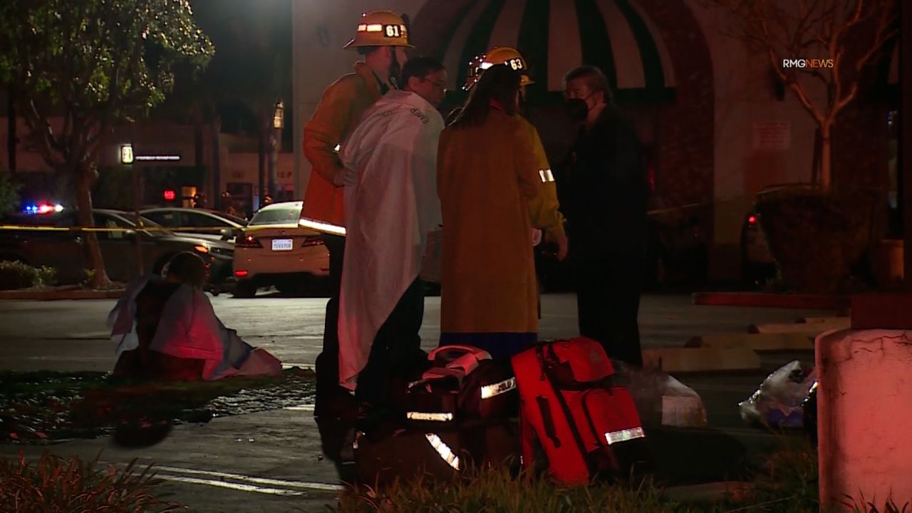 Rescue workers assist a man following the shooting. 