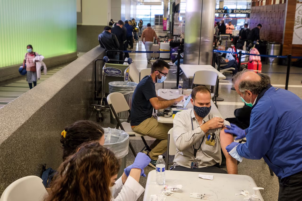 People are vaccinated at Los Angeles International Airport on December 22, 2021.