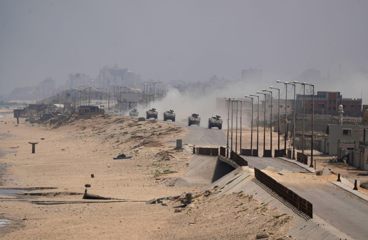 Israeli armored vehicles drive through Deir al-Balah, Gaza, on June 8.