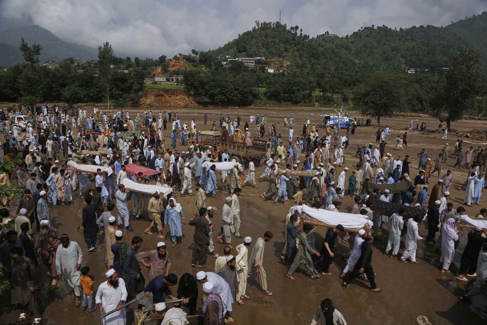 People carry the bodies of victims of Friday's <a href="index.php?page=&url=https%3A%2F%2Fwww.cnn.com%2Fclimate%2Fgallery%2Fphotos-pakistans-deadly-monsoon-floods">flash flooding</a> after funeral prayers at a village near Pir Baba in northwest Pakistan on Saturday, August 16. Floods have claimed the lives of <a href="index.php?page=&url=https%3A%2F%2Fndma.gov.pk%2Fsitrepm" target="_blank">at least 500 people</a> in the country since late June as heavy rain batters the country; almost half were children.