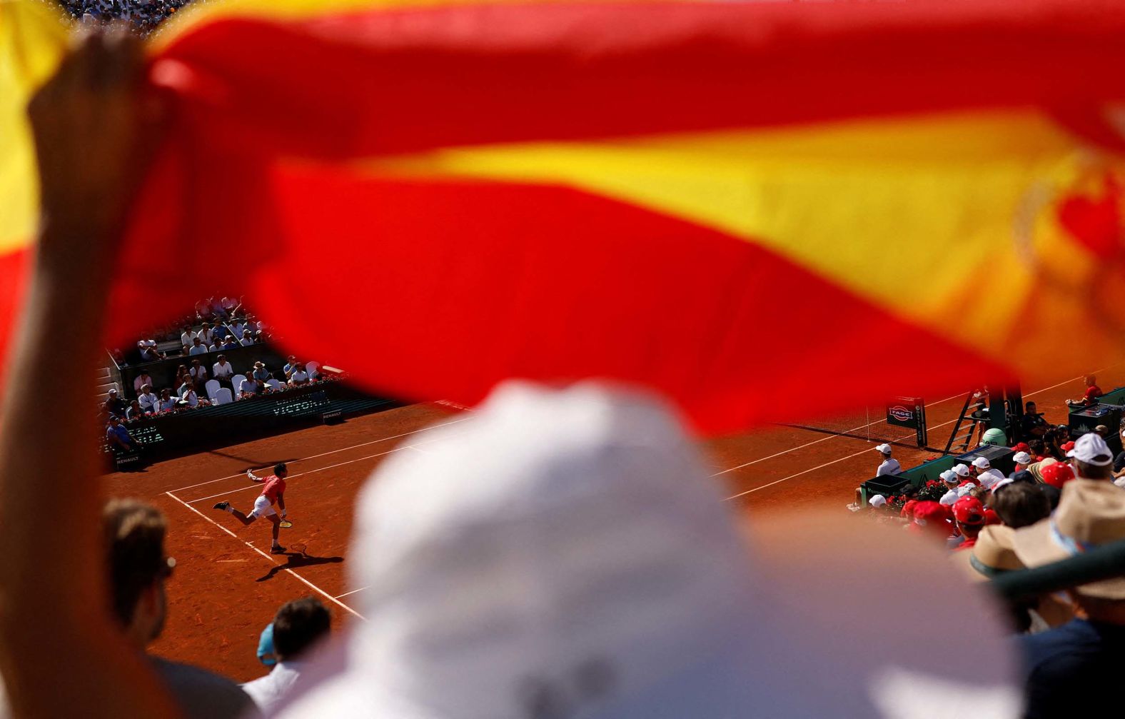 A spectator waves a Spanish flag as Jaume Munar competes in a Davis Cup qualifier in Marbella, Spain, on Saturday, September 13.