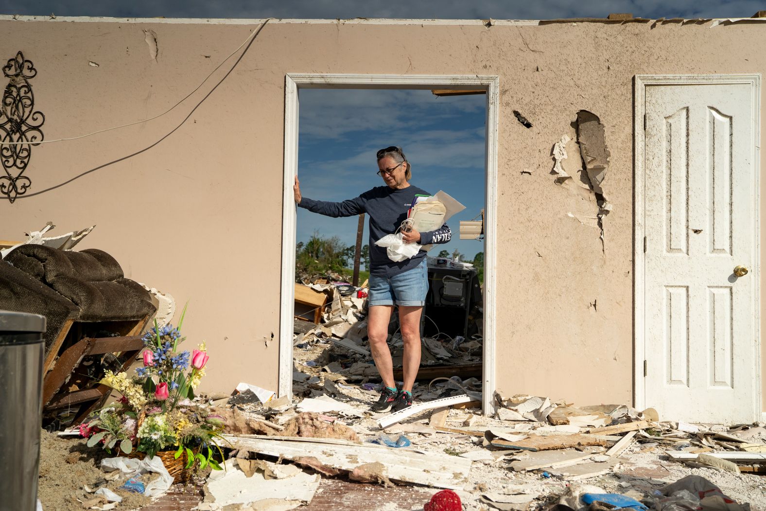 Lesly Karen Cornett stands among what’s left of her house in London, Kentucky, on Sunday, May 18. <a href="https://www.cnn.com/2025/05/17/weather/tornadoes-severe-weather-deaths-climate-hnk">A violent, tornado-spawning storm system</a> tore across the central United States, leaving at least 25 people dead in Missouri and southeastern Kentucky. Cornett and her husband took shelter in their bathtub.