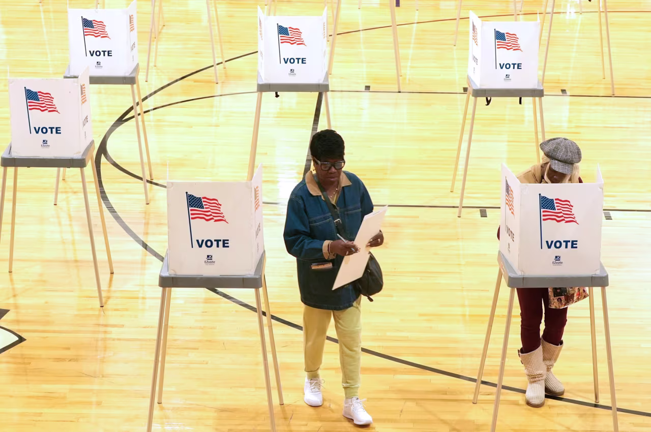 People vote at in the gymnasium at the Kennedy School in Pontiac, Michigan.