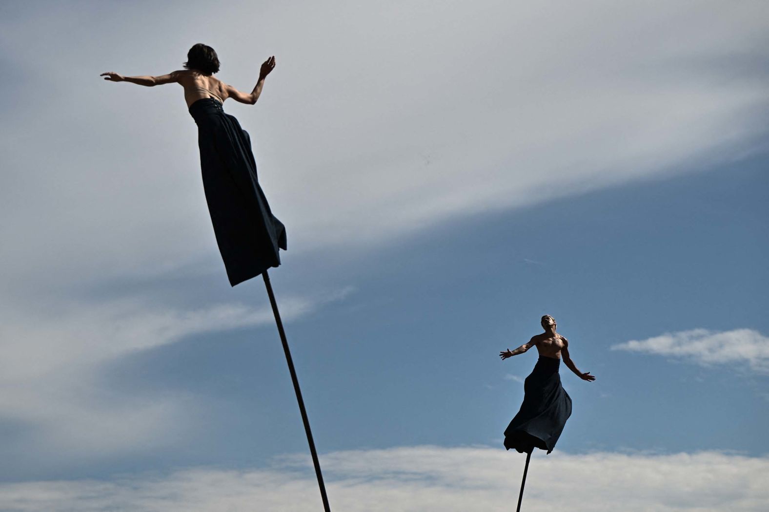 Performers of the French aerial theater company Gratte Ciel balance on stilts during a performance at the FAB International Arts Festival in Bordeaux, France, on Saturday, September 27.