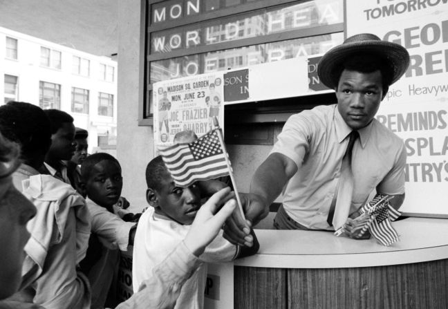 Foreman hands out miniature American flags at New York's Madison Square Garden in 1969.