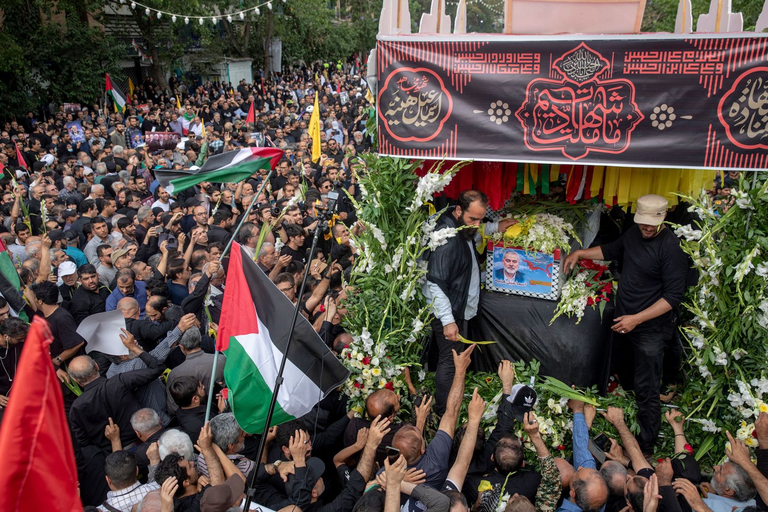 People in Tehran attend a memorial Thursday, August 1, for Hamas political leader Ismail Haniyeh, who was assassinated in the Iranian capital on Wednesday. <a href="index.php?page=&url=https%3A%2F%2Fwww.cnn.com%2F2024%2F08%2F01%2Fmiddleeast%2Fismail-haniyeh-iran-explosion-bomb-planted-intl%2Findex.html">Haniyeh was killed by an explosive device</a> that had been hidden in the guest house where he was staying, a source told CNN. The Iranian government and Hamas say Israel carried out the assassination. Israel has neither confirmed nor denied its involvement.
