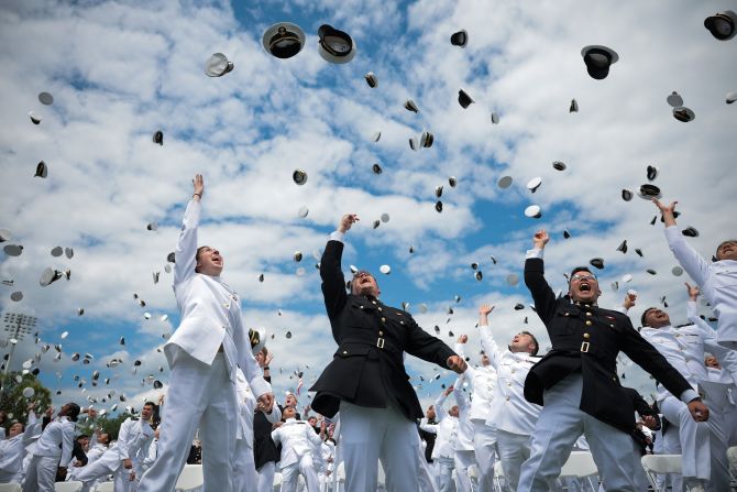Graduates of the US Naval Academy celebrate by throwing their caps into the air during a ceremony in Annapolis, Maryland, on Friday, May 23.