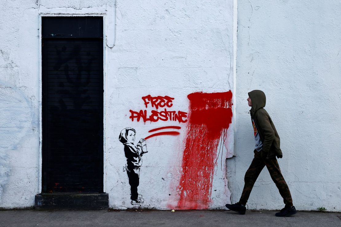 A man walks past graffiti reading 'Free Palestine', amid the ongoing conflict between Israel and the Palestinian Islamist group Hamas, in Dublin, Ireland, November 15.