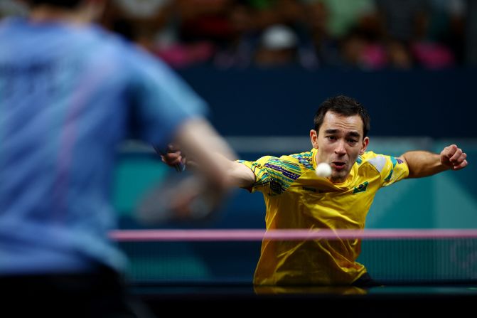 Brazilian table tennis player Hugo Calderano hits a shot during his quarterfinal match against South Korea's Jang Woo-jin on August 1. Calderano won and became the first South American table tennis player to reach an Olympic semifinal in men's singles.