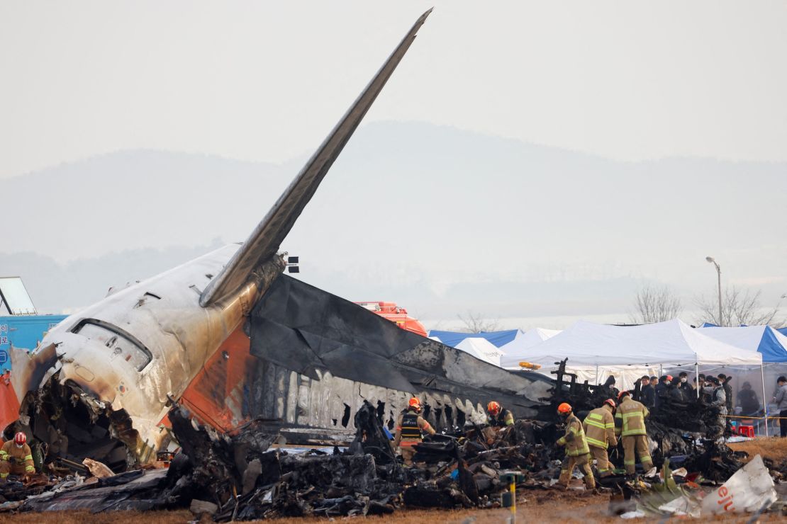 People work at the site where a Jeju Air flight crash landed at Muan International Airport, South Korea, on December 30.