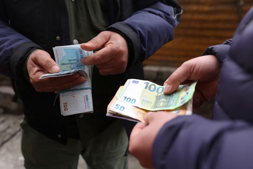 A currency dealer counts Iranian rials as the value of the Iranian rial drops, in Tehran, Iran, February 9.