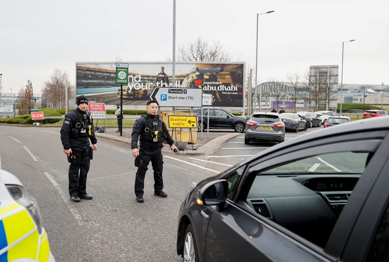 Police guide traffic outside Terminal 5 at the Heathrow Airport.