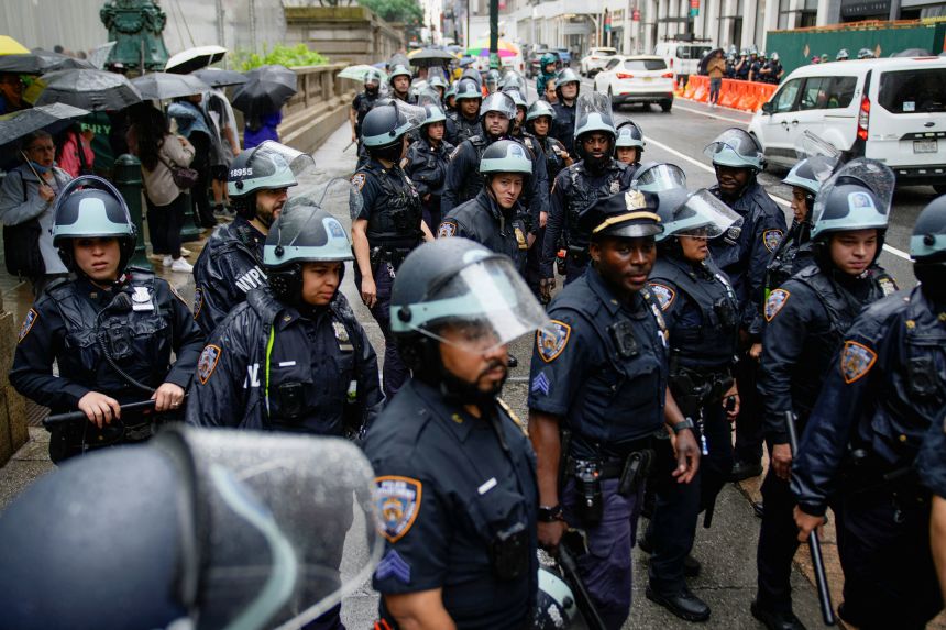 NYPD officers await the start of a protest on June 14.