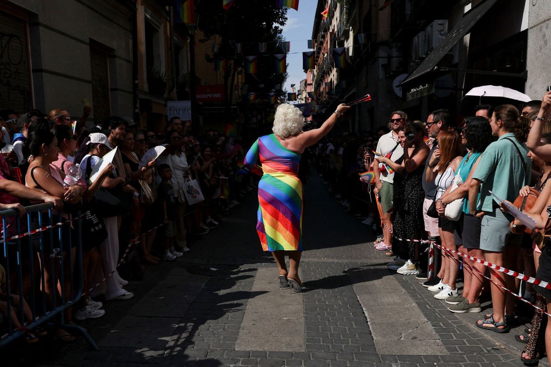 A presenter walks amid the crowds before the start of the races.