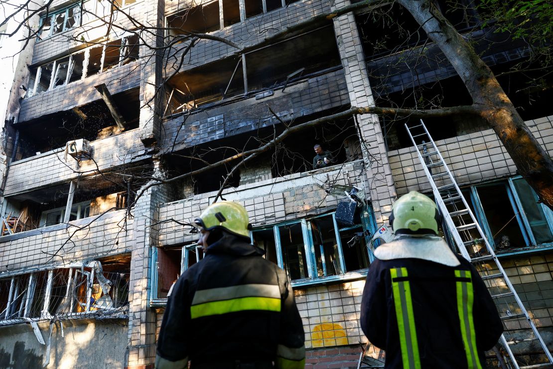 Firefighters work at an apartment building which was damaged during Russian drone and missile strikes in Kyiv on July 4.