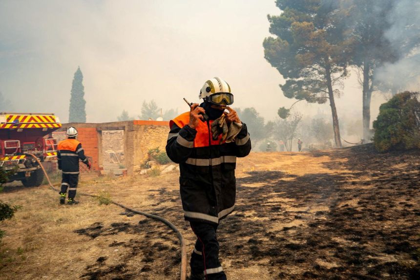 Firefighters work at the scene of a wildfire near Saint-Laurent-de-la-Cabrerisse, France, on Wednesday.