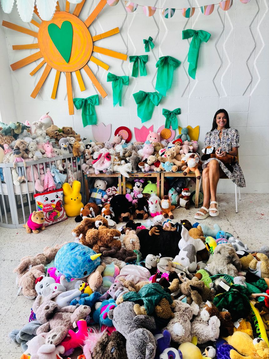 Annie Gully smiles with the hundreds stuffed animals donated to help children impacted by the flooding in Kerr County, Texas.