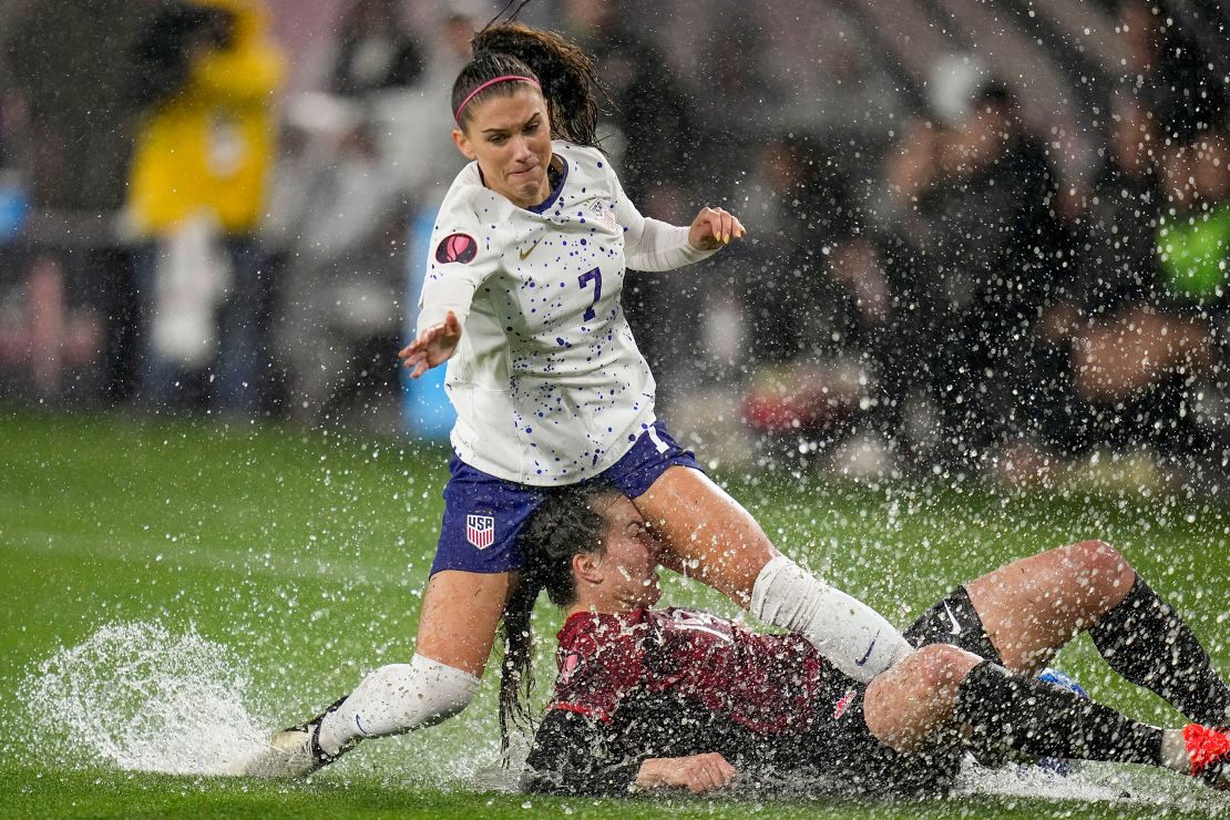 Alex Morgan of the US collides with Canada's Vanessa Gilles.