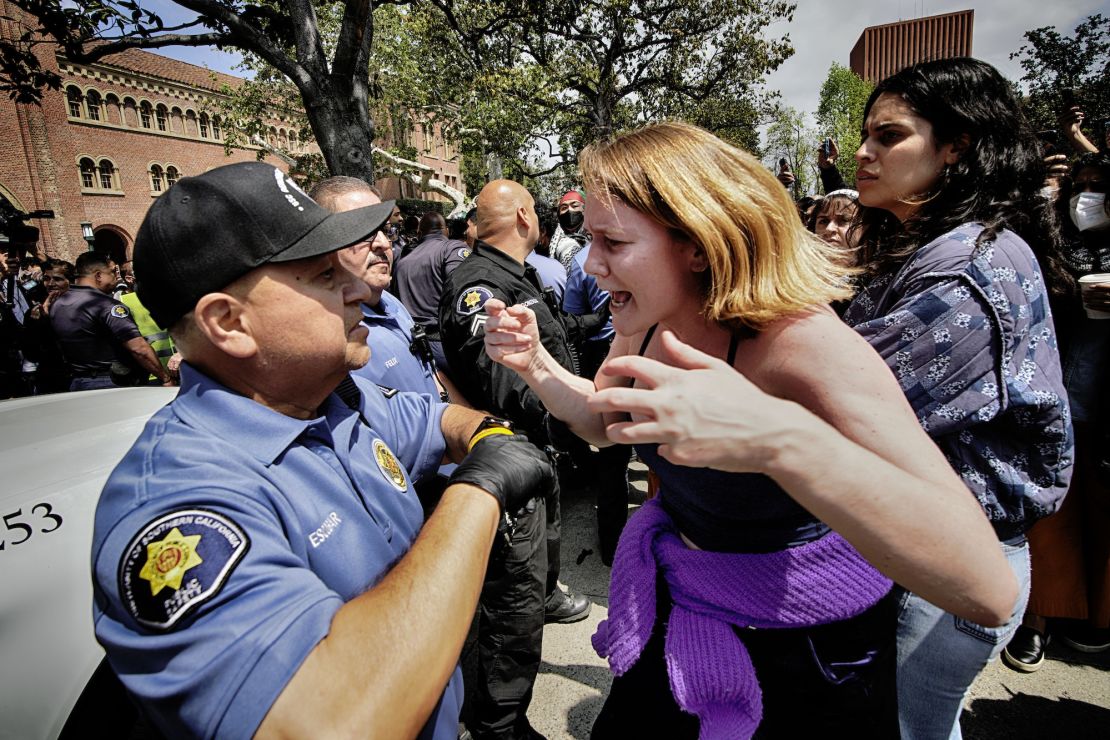 A University of Southern California protester, right, confronts a University Public Safety officer at the campus' Alumni Park during a pro-Palestinian occupation Wednesday in Los Angeles.