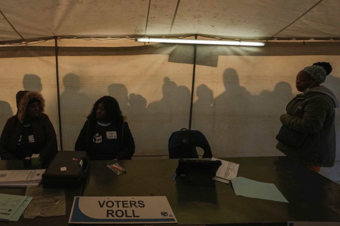 Electoral workers prepare to open the voting station as voters line up to cast their ballot for general elections in Alexandra, near Johannesburg, South Africa, Wednesday, May 29, 2024. (AP Photo/Themba Hadebe)