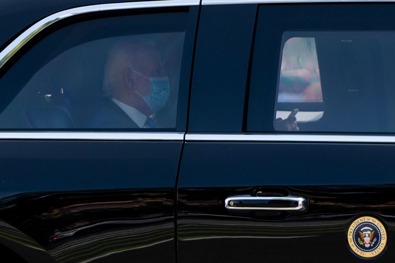 Biden wears a mask while returning to the White House on July 23. He tested positive for Covid-19 a few days before he dropped out of the race, and he spent the weekend at his beach house in Rehoboth Beach, Delaware. He was in Delaware when he announced his decision to drop out.