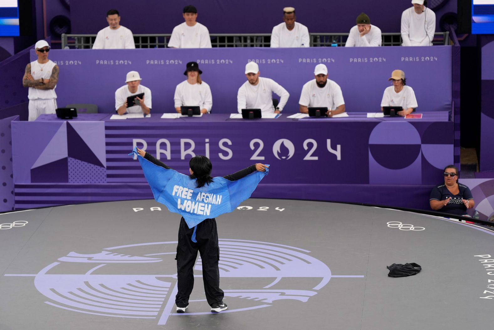 Manizha Talash <a href="https://www.cnn.com/sport/live-news/paris-olympics-news-2024-08-09#h_e99c738431cb8d6570d71599832f2bcc">wears a cape that says "free Afghan women"</a> as she takes part in the breaking competition on August 9. The 21-year-old fled Afghanistan after the Taliban began seizing control in 2021. She is now living in Spain, but she is representing the Refugee Team at the Olympics.