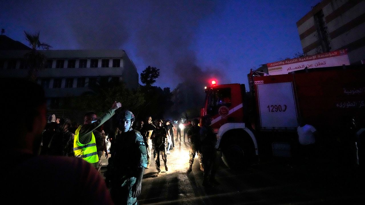 Rescue teams arrive near the site of Friday's strike.