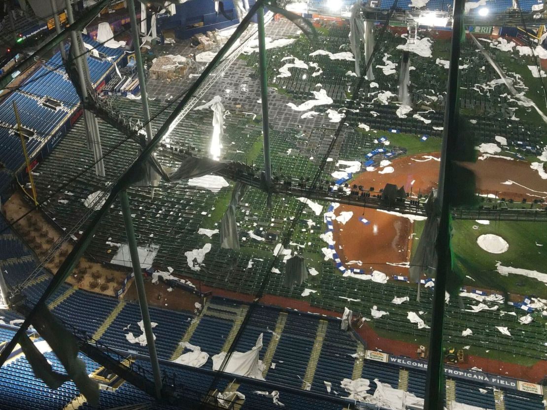 Drone footage over St. Petersburg's Tropicana Field shows the dome's mangled roof and cots for first responders.