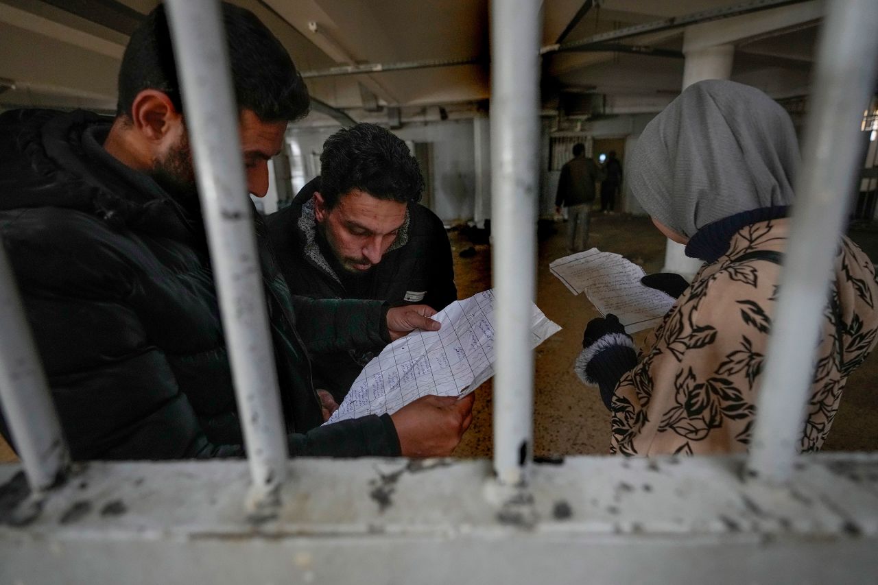 People inspect documents they found in the Saydnaya military prison, just north of Damascus, Syria, on December 9.