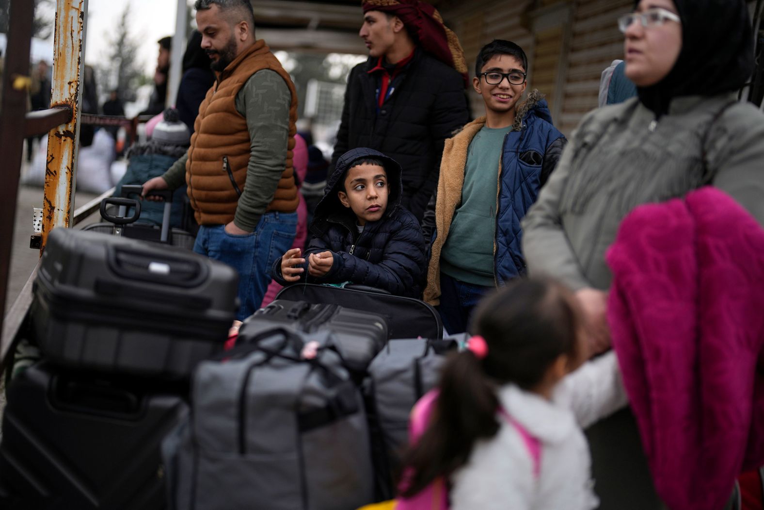 People wait to cross into Syria at the Oncupinar border gate, near the town of Kilis, Turkey, on December 12.