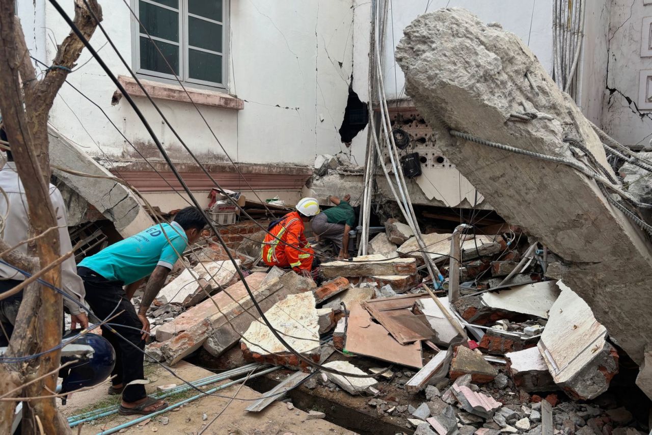 Gente busca supervivientes bajo un edificio dañado en Naypyidaw. La junta militar de Myanmar declaró el estado de emergencia en gran parte del centro del país.