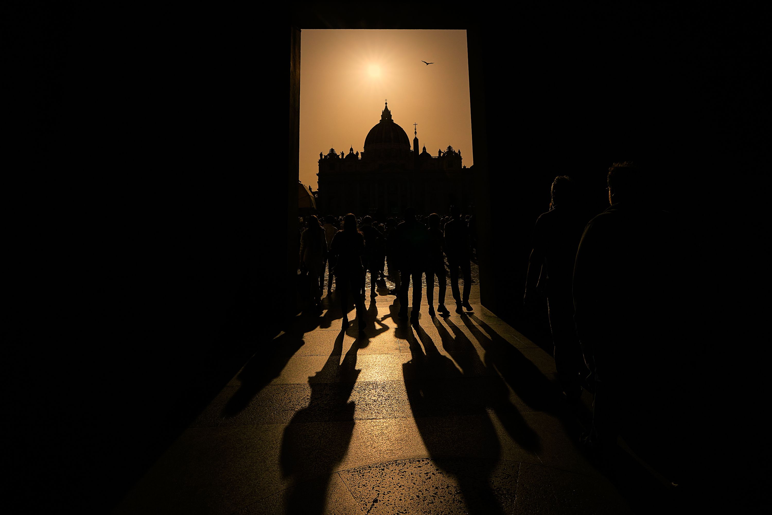 People walk around St. Peter's Square on Tuesday.