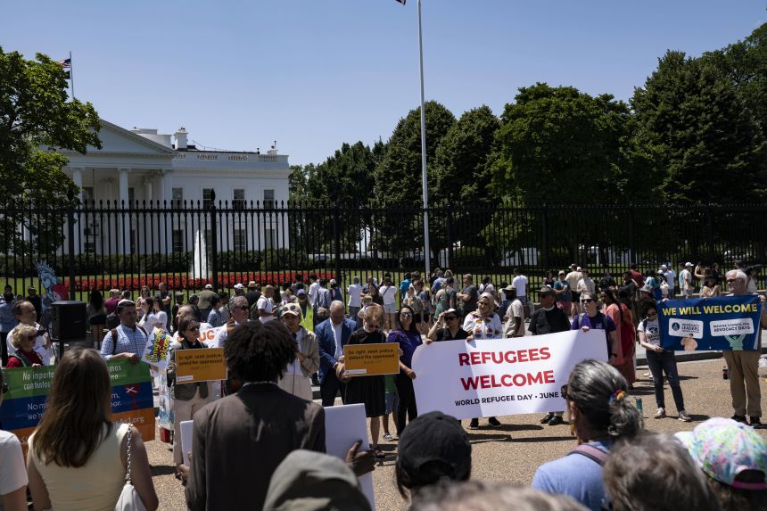 A group protests outside the White House against Trump's visa ban on refugees and immigrants who come to the US for school in Washington, DC, on June 20.