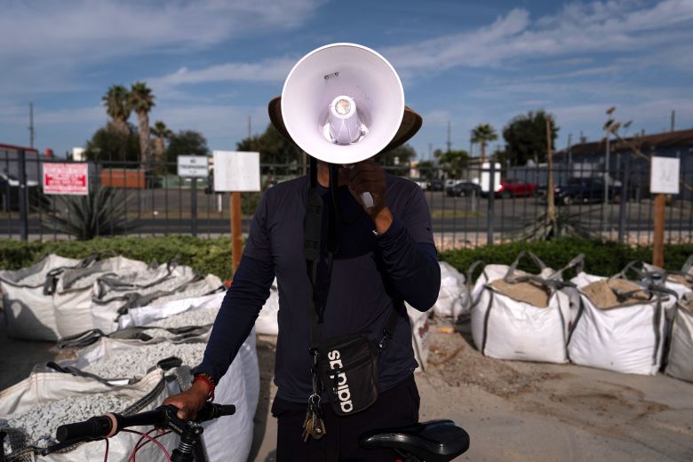 A man poses with a megaphone used to alert other day laborers of ICE operations in a Home Depot parking lot in the Van Nuys section of Los Angeles, on August 28.