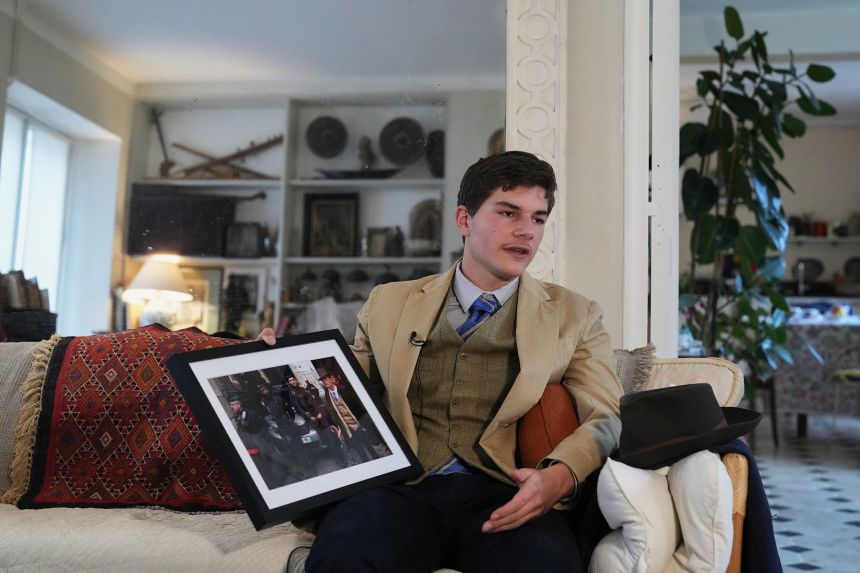 Pedro Elias Garzon Delvaux holds an Associated Press photo taken outside the Louvre on the day of the Crown Jewels heist in Rambouillet, south of Paris.