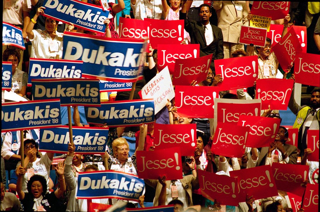 Delegates display opposing candidate choices during the opening session of the 1988 Democratic National Convention in Atlanta, Georgia.
