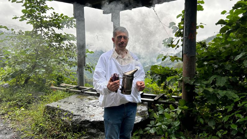 <strong>Bee-smoker:</strong> Beekeeper Hasan Kutluata uses pine wood in his smoker to calm the bees.