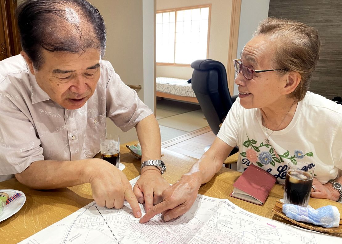 World War II Kumagaya firebombing survivor Kazue Hojo, 87, and Shoichi Yoshida, administrator for a local civic group devoted to preserving the history of the bombing, locate her house on a map of the city from 1945.
