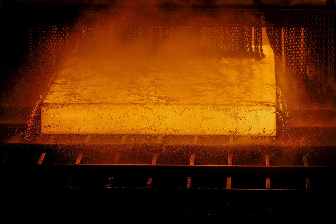 A red hot steel slab passes through a rolling machine inside the hot strip mill unit at the Rourkela Steel Plant in Odisha, India, on Friday, June 21, 2019.