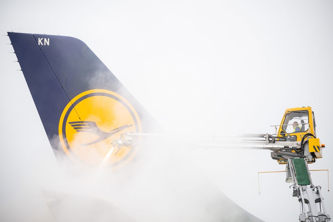 A Lufthansa aircraft is deiced before takeoff at Frankfurt Airport in February 2023.