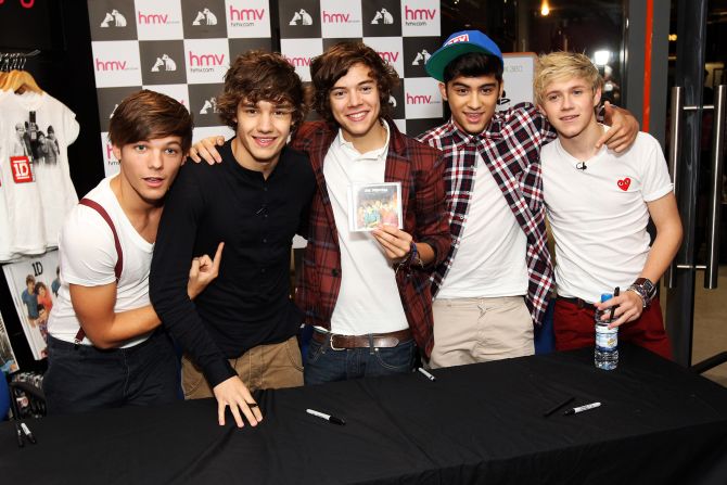 The members of One Direction sign CDs before the launch of their first single in 2011.