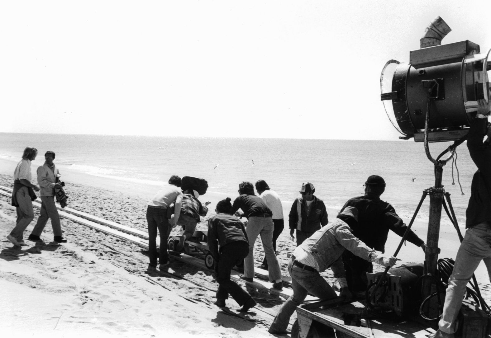 Scheider, second from left, films a scene from the opening of "Jaws," when the people of Amity Island still don't quite fear the water.