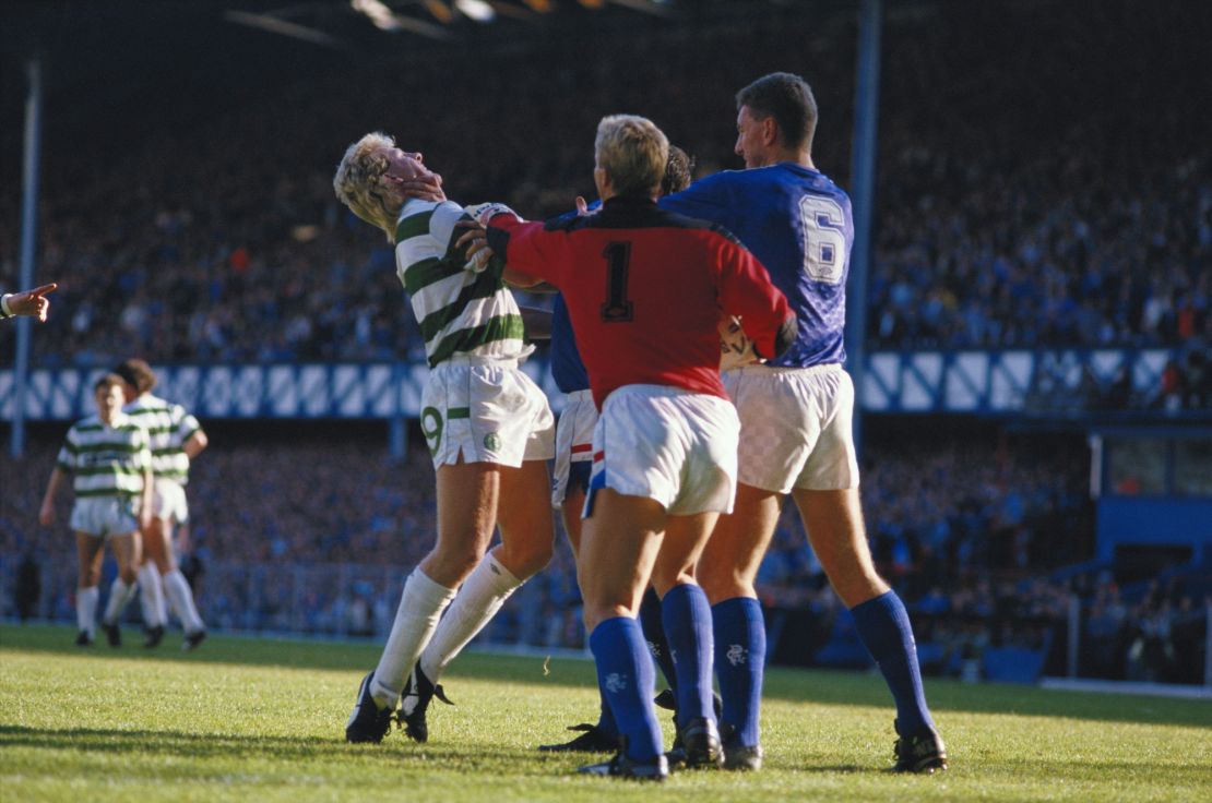 Frank McAvennie of Celtic is grabbed by the throat by a Rangers player as Chris Woods #1 and Terry Butcher #6 also of Rangers step in during the Scottish Premier League match at Ibrox Stadium in Glasgow, Scotland, 1985.