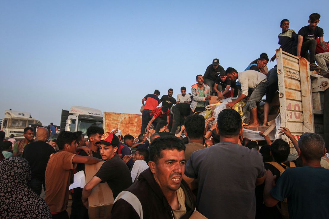 Palestinians distribute food from the United Nations, in Wadi Gaza, central Gaza, on May 18. Aid workers say they can barely meet humanitarian demands on the ground.