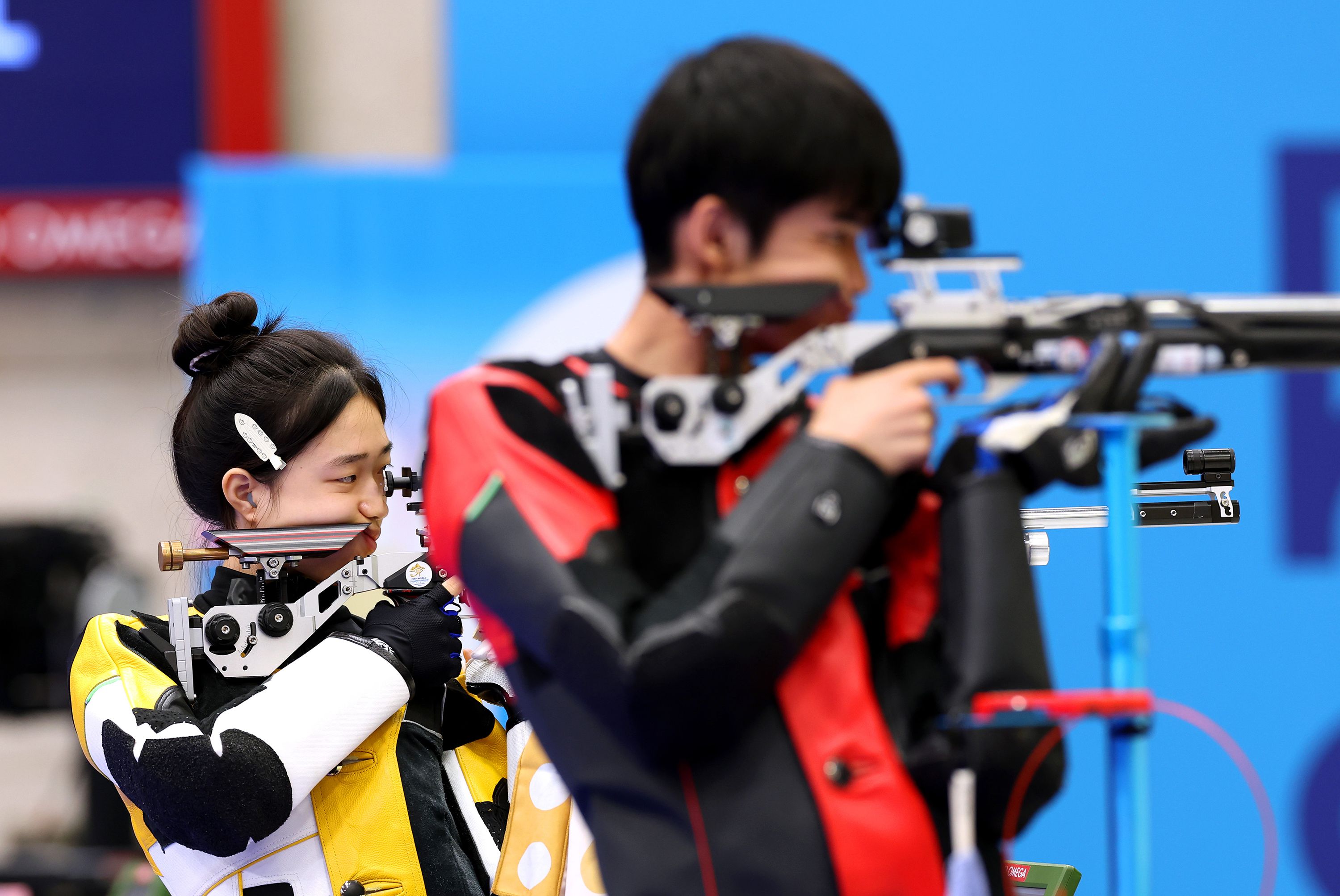 China’s Huang Yuting, left, competes in the 10-meter air rifle mixed-team shooting competition with Sheng Lihao on July 27. <a href="https://www.cnn.com/sport/live-news/paris-olympics-news-2024-07-27#h_93b948f94523253e5a87b1f0890e07ed">They won the first gold medal of the Paris Olympics</a>.