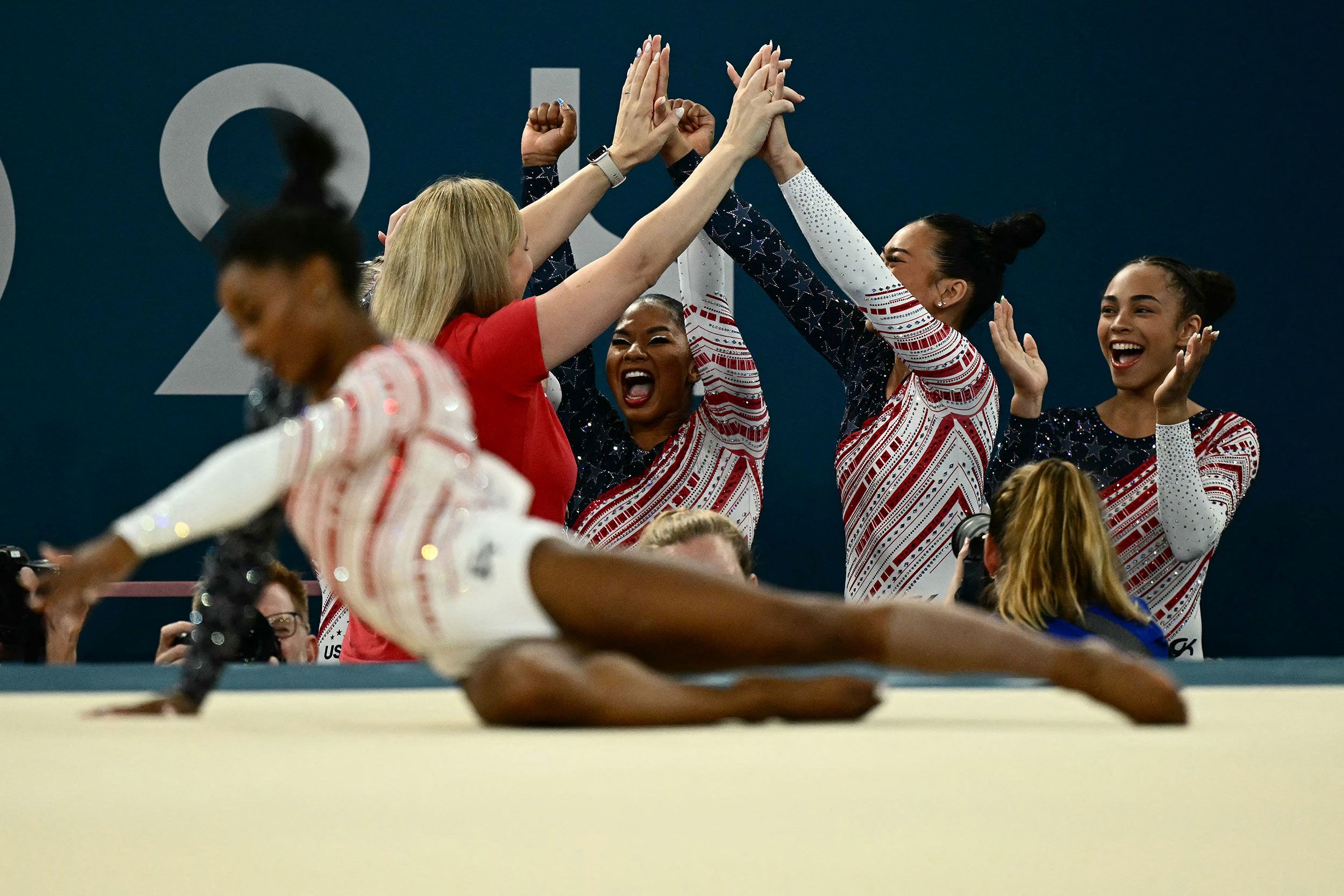 Team USA celebrates as Biles finishes her floor exercise at the end of the competition. Biles needed only 8.865 points to claim gold. She scored a 14.666.